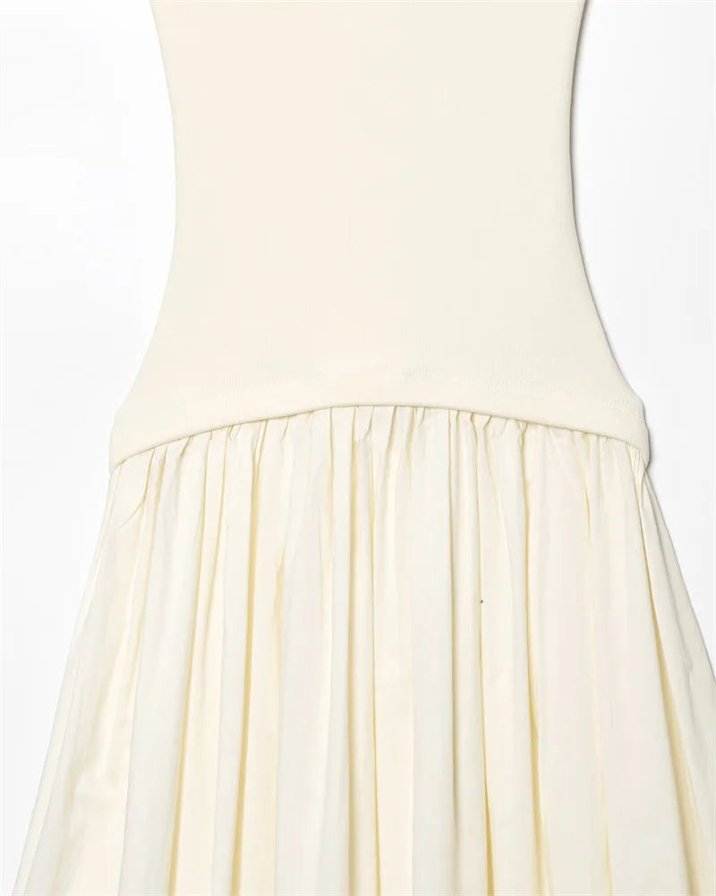 Close-up of a cream-colored dress with a plain background