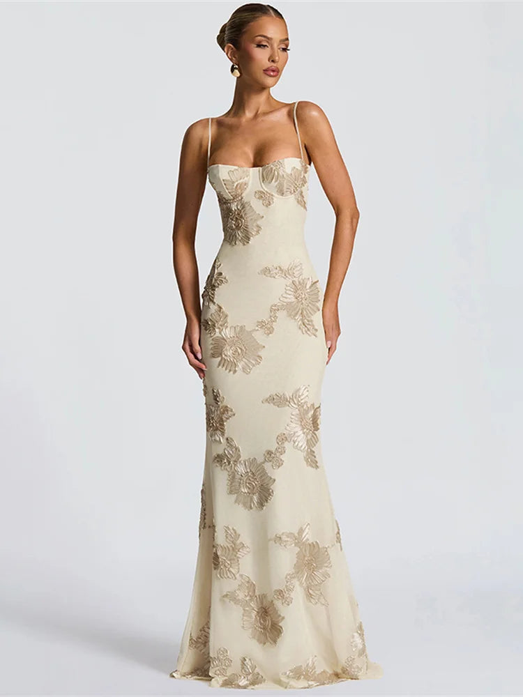 Woman wearing a floral lace evening gown on a white background
