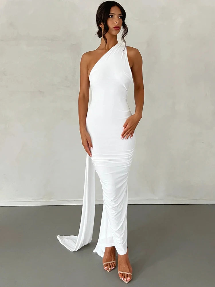 Woman wearing a white one-shoulder dress against a plain background