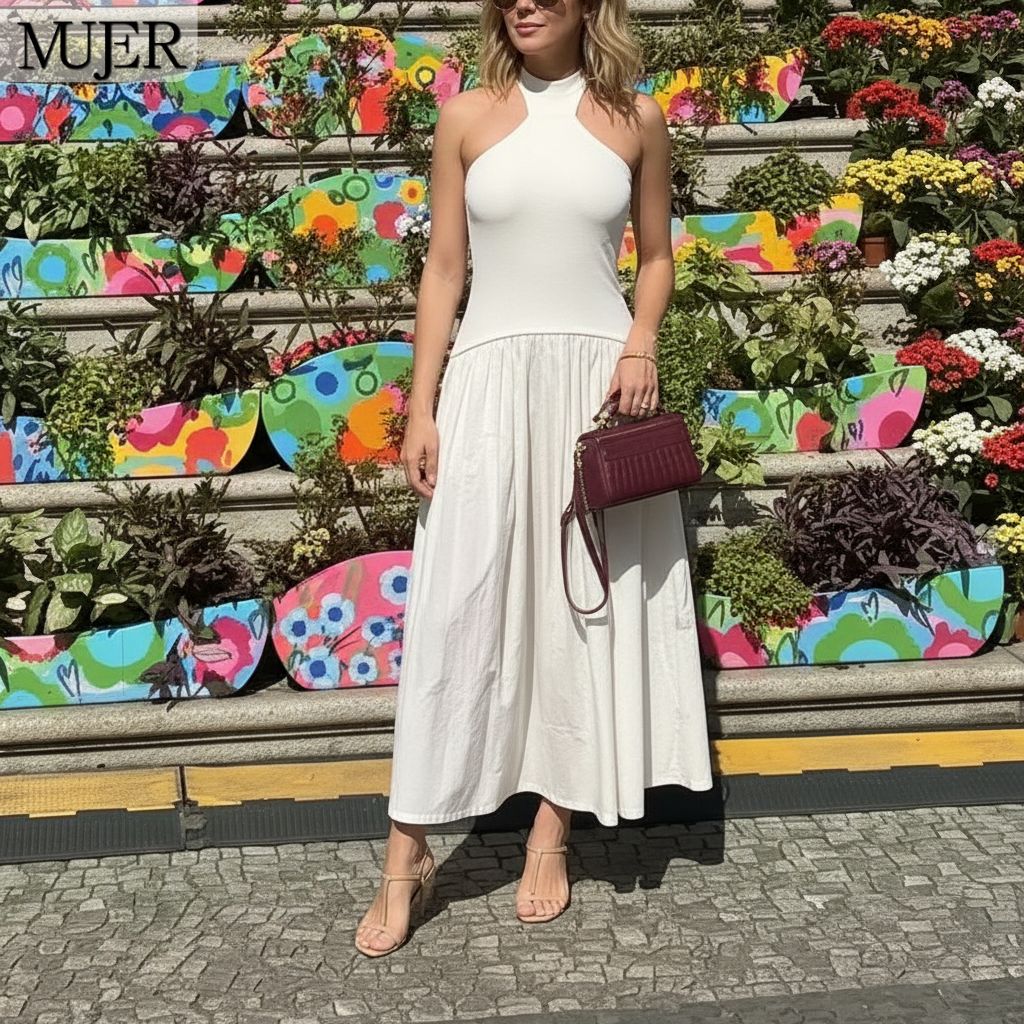 Woman in a white dress standing in front of a colorful floral display with 'MUJER' branding.